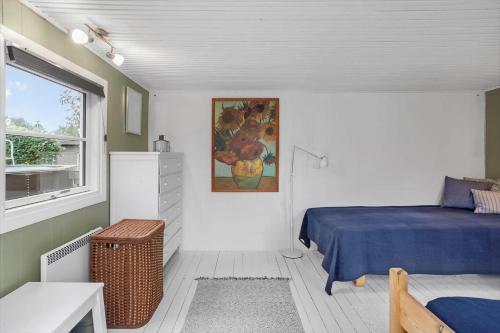 a small bedroom with a bed and a window at 1111-Stege-Ulvshalevej-111 in Stege