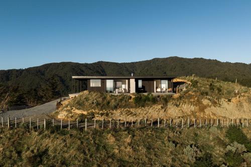 a house on top of a hill at The Hide Kapiti Accommodation in Paraparaumu