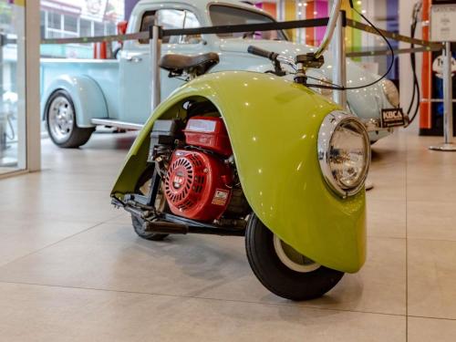 a green motor scooter parked in a museum at Ibis Styles Balneário Camboriú - 1 Quadra do Mar in Balneário Camboriú