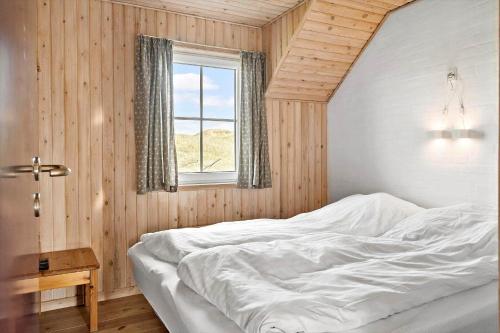a bedroom with a white bed and a window at 380-Harboore-Bethaniavej-9 in Harboør