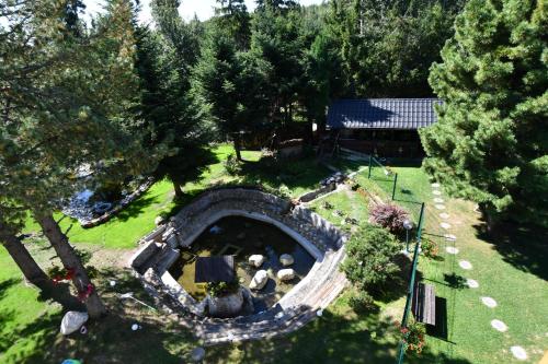 an aerial view of a garden with a stone structure at Penzion Pažický in Tatranská Lomnica