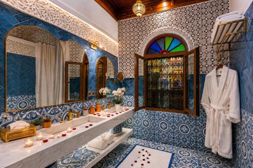 a bathroom with two sinks and a mirror at Riad Fes Palais Bab Sahra Suites & Cooking Workshops in Fez