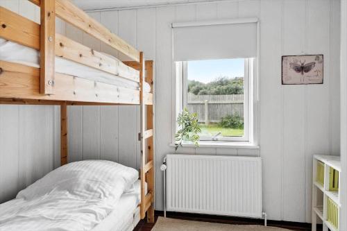 a bedroom with a bunk bed and a window at 724-Thyboron-Kirkevej-9 in Thyborøn