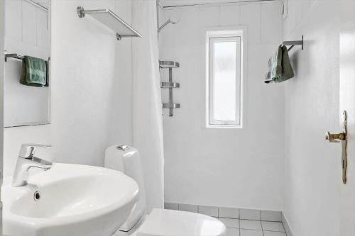 a white bathroom with a sink and a toilet at 724-Thyboron-Kirkevej-9 in Thyborøn