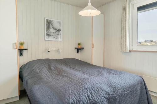 a bedroom with a bed and a window at G143-Lemvig-Syrenvej-43 in Lemvig