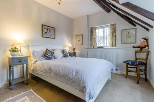 a bedroom with a bed and a chair and a window at 2 Bed in Ludlow oc-78885 in Ludlow