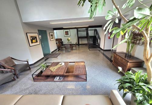 a living room with a couch and a coffee table at Via Contorno Hotel in Belo Horizonte