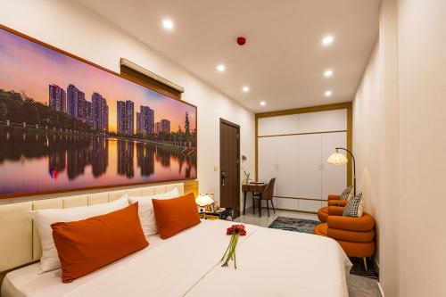a bedroom with a bed with a large painting on the wall at Aura Retreat Boutique Hotel Hanoi in Hanoi