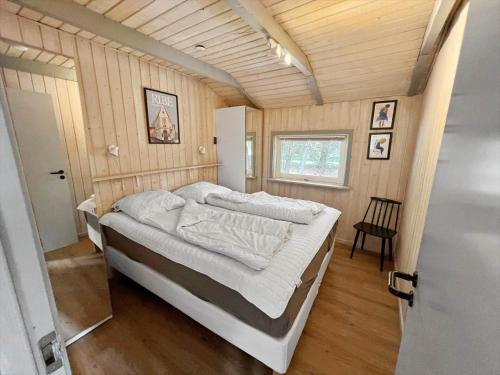 a bedroom with a large bed in a room at 0048-Romo-Trinnesvej-12 in Høm