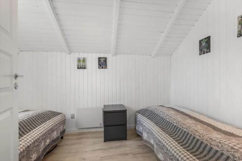 two beds in a room with white walls at 0294-Romo-Vestergade-3-Ap-57 in Høm
