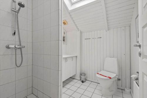 a white bathroom with a shower and a toilet at 0294-Romo-Vestergade-3-Ap-57 in Høm