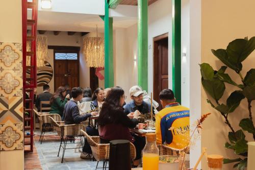 a group of people sitting at tables in a restaurant at Casa Aura Hotel in Bogotá