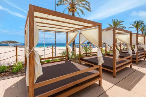 a couple of beds on the beach at INNSiDE by Meliá Wave Calviá in Magaluf