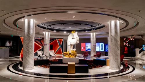 a lobby with a statue in the middle of a building at Radisson RED Shanghai Wujiaochang Hotel in Shanghai