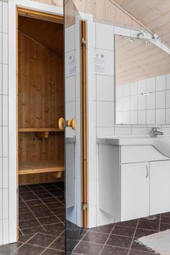 a white kitchen with a sink and a counter at 2608-Romo-Sonderstrandvej-18 in Høm