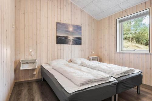 a bedroom with a bed in a room with a window at 2807-Romo-A-Hveyselsvej-28 in Høm