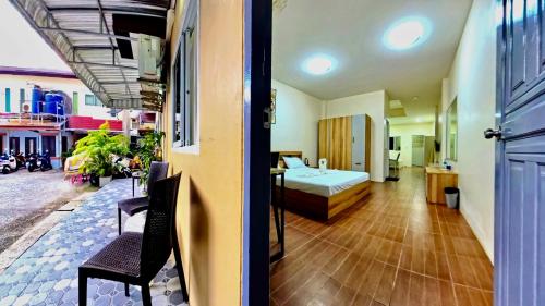 a hotel room with a bed and a bedroom with a table at Vista Residence Patong in Patong Beach