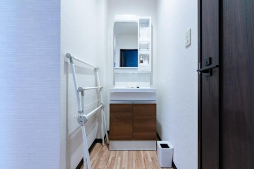 a bathroom with a sink and a mirror at STEP by STEP - Vacation STAY 25751v in Kanayama