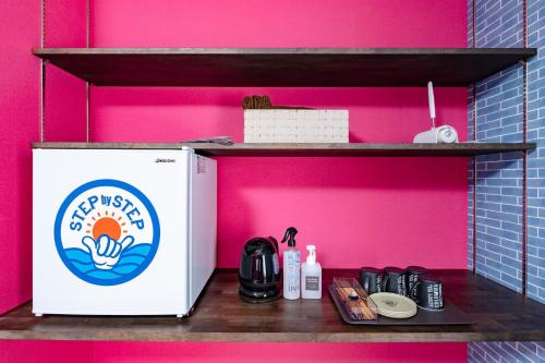 a pink wall with a shelf next to a refrigerator at STEP by STEP - Vacation STAY 25756v in Kanayama