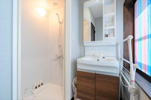 a bathroom with a sink and a mirror at STEP by STEP - Vacation STAY 25756v in Kanayama