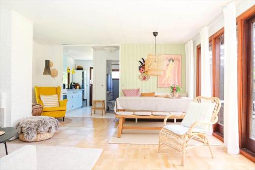 a living room with a bed and a table and chairs at 10000-1-Rorvig-Birkealle-2-A in Rørvig