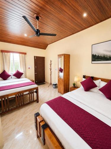 a bedroom with two beds and a ceiling at VIVIPRA Habitat, Coorg in Madikeri