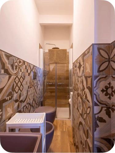 a bathroom with a shower and a toilet in it at Rooftop Maisonette - Old Town by TrulloVista in Martina Franca