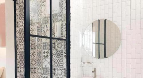 a bathroom with a shower with a mirror and a sink at The Room Hotel in Ban Nong Puk