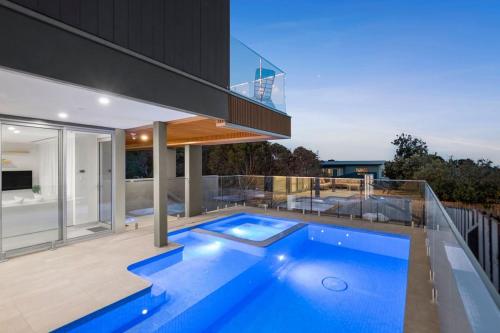 a house with a blue swimming pool on a balcony at Casa Lux in Aireys Inlet