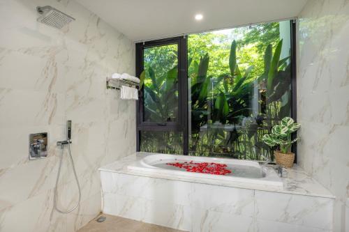 a bathroom with a bath tub with a window at Luxury Mountain View 3BR Villa Pool 10ppl in Phúc Yên