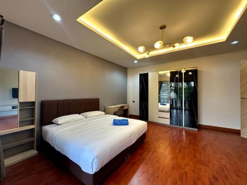 a bedroom with a large bed with a ceiling at The Horizon Villa Songkhla in Ban Mai