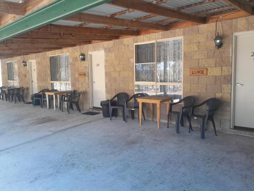 a row of tables and chairs in a building at Murray Gardens Motel in Stanthorpe