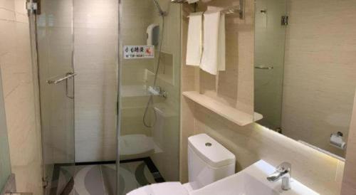 a bathroom with a shower and a toilet and a sink at Hong Thai Hotel in Macau