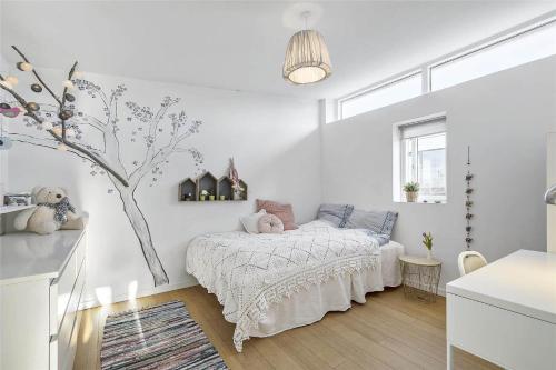 a bedroom with a bed and a tree in it at 13317-Asnaes-Mollestraedet-4 in Asnæs