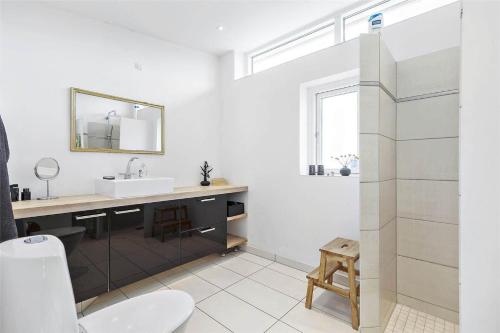 a white bathroom with a sink and a mirror at 13317-Asnaes-Mollestraedet-4 in Asnæs