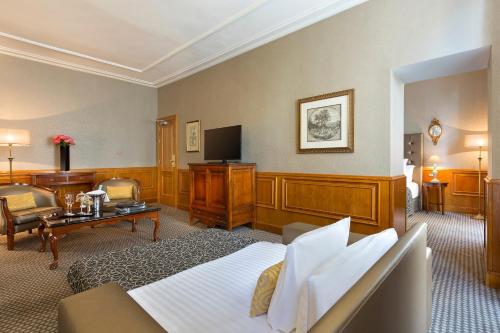 a hotel room with a bed and a television at Meliá Paris Vendôme in Paris