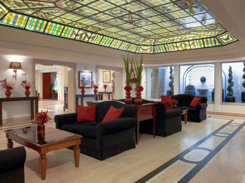 a living room with a stained glass ceiling at Meliá Paris Vendôme in Paris