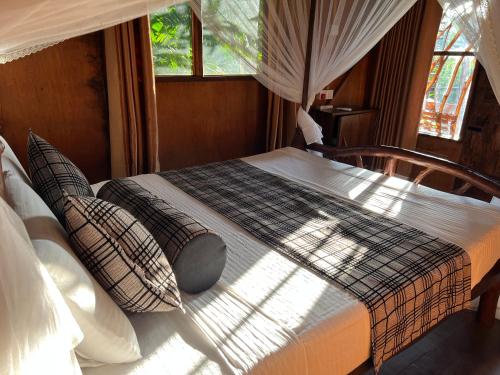 a bed in a room with a window at Sigiriya Rock Gate Resort in Sigiriya