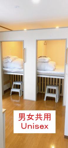 a room with two bunk beds in a room at HOSTEL198 Unisex dormitory cabin typeーVacation STAY68082v in Osaka
