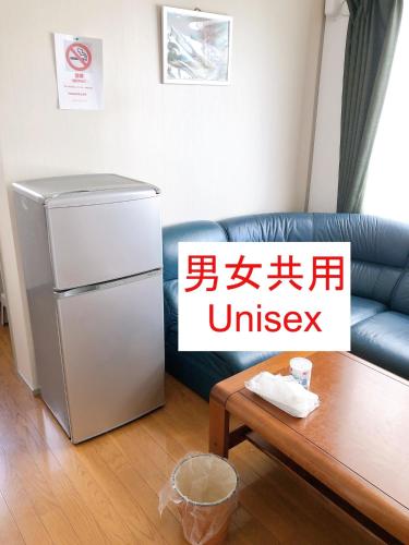 a living room with a refrigerator and a table at HOSTEL198 Unisex dormitory cabin typeーVacation STAY68082v in Osaka