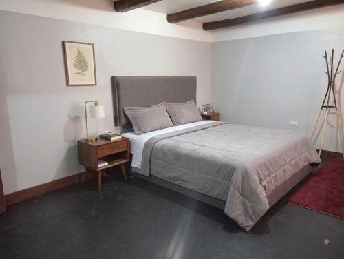 a bedroom with a large bed and a nightstand with a bed sidx sidx sidx at Anta lodge in Huaraz