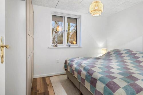 a bedroom with a bed and a window at FJ1202-Jaegerspris-Lille-Engvej-7 in Jægerspris