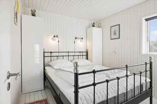 a bedroom with a black bed and a window at FJ2403-Skibby-Hybenvaenget-27 in Skibby