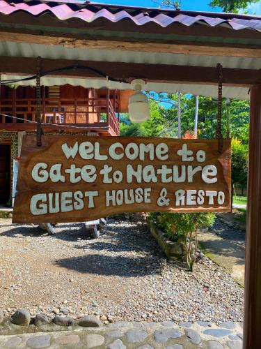 a sign that says welcome to a gate to nature guest house and nest at Gate to Nature - guesthouse and jungle trek in Bukit Lawang