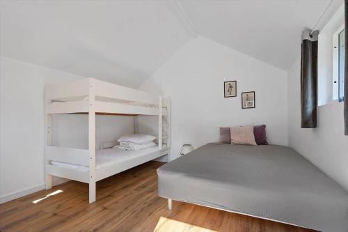 a bedroom with a bed and a bunk bed and a bunk bed at FJ1404-Jaegerspris-Strandstien-17 in Jægerspris