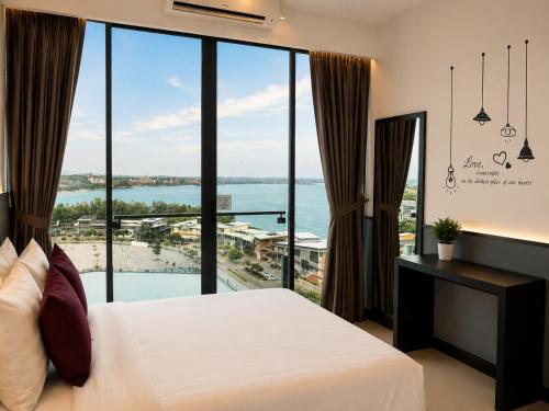 a bedroom with a bed and a large window at D'Wharf Hotel & Serviced Residence in Port Dickson