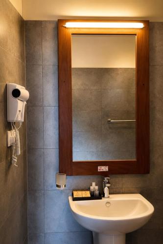 a bathroom with a sink and a mirror at Oak Ray Sky Terrace in Kandy