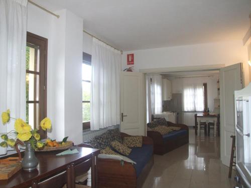 a living room with a couch and a table at Huge Holiday Home in Marina di Castagneto Carducci near Sea in Donoratico