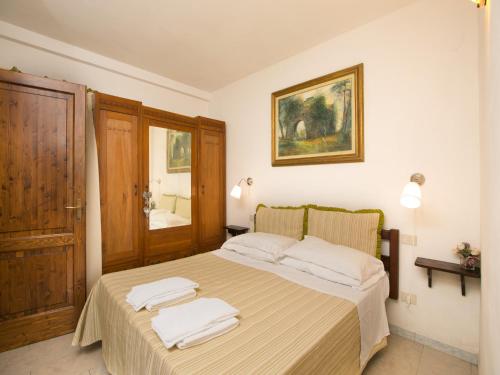 a bedroom with a bed with two towels on it at Huge Holiday Home in Marina di Castagneto Carducci near Sea in Donoratico