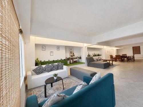 a living room with two couches and a table at Gao Check in Phala Beach Front in Rayong